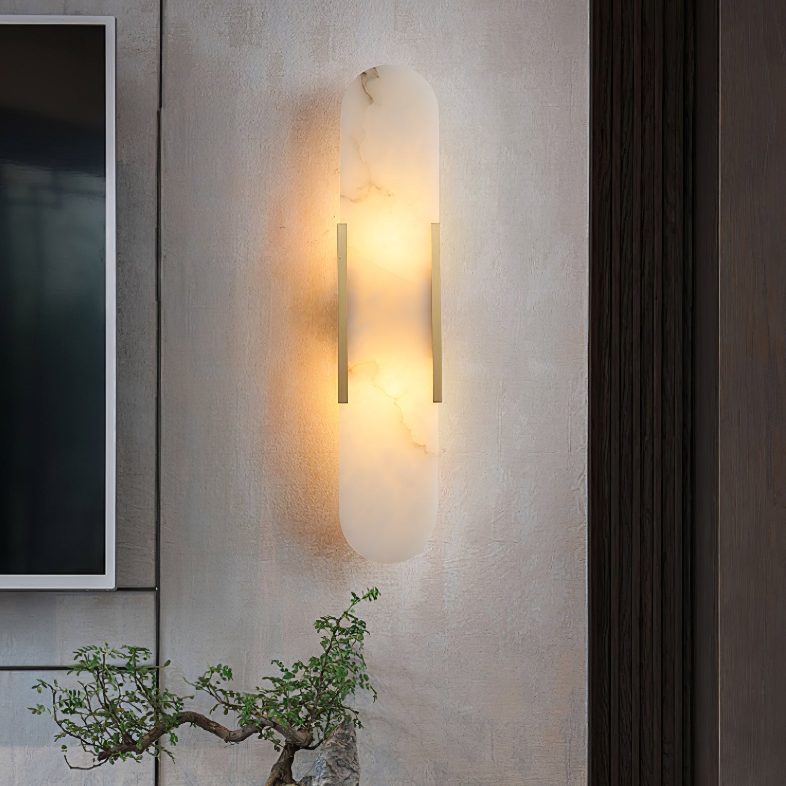 Clérachic sconce glowing on a textured plaster wall next to dark timber panelling, a bonsai below