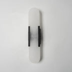 Clérachic sconce turned slightly, unlit, the dark bars and cloudy stone shown against plain white
