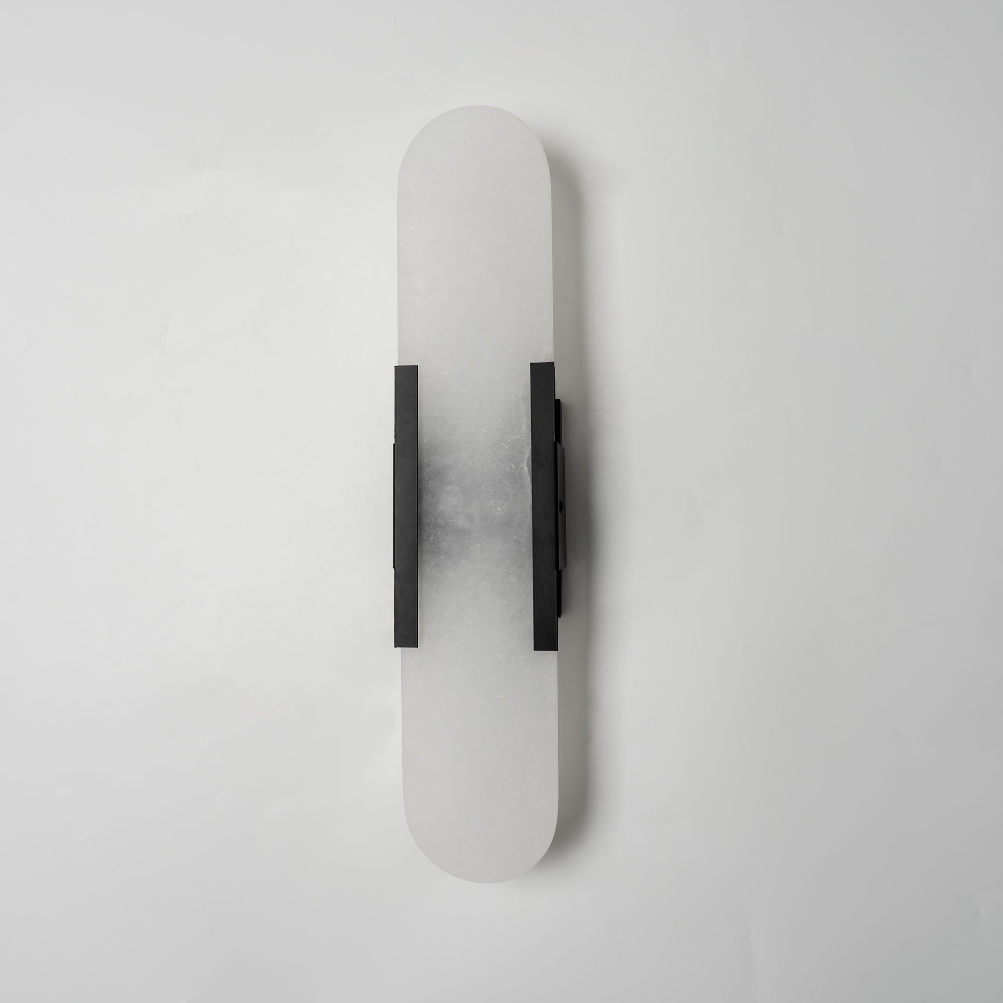 Clérachic sconce turned slightly, unlit, the dark bars and cloudy stone shown against plain white