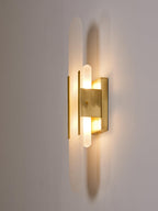 Clérachic sconce lit and turned three-quarters right, showing the depth of the brass mount