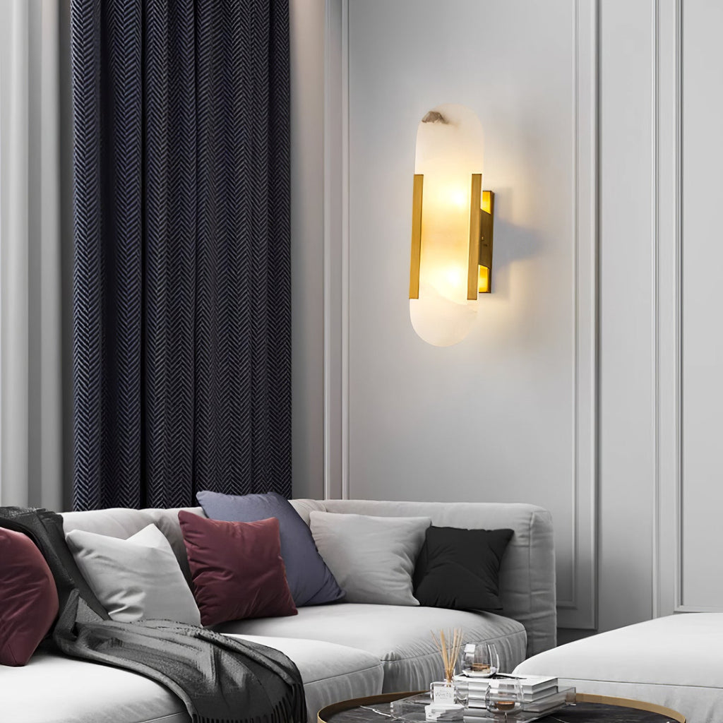 Clérachic sconce lit on a panelled living-room wall above a white sofa with berry and grey cushions