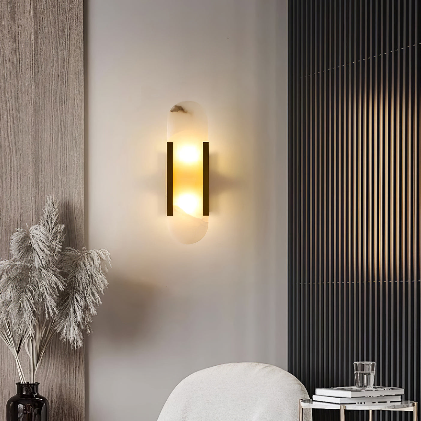 The Clérachic sconce lit in a corner beside a dark timber slat panel, pampas grass and a boucle chair
