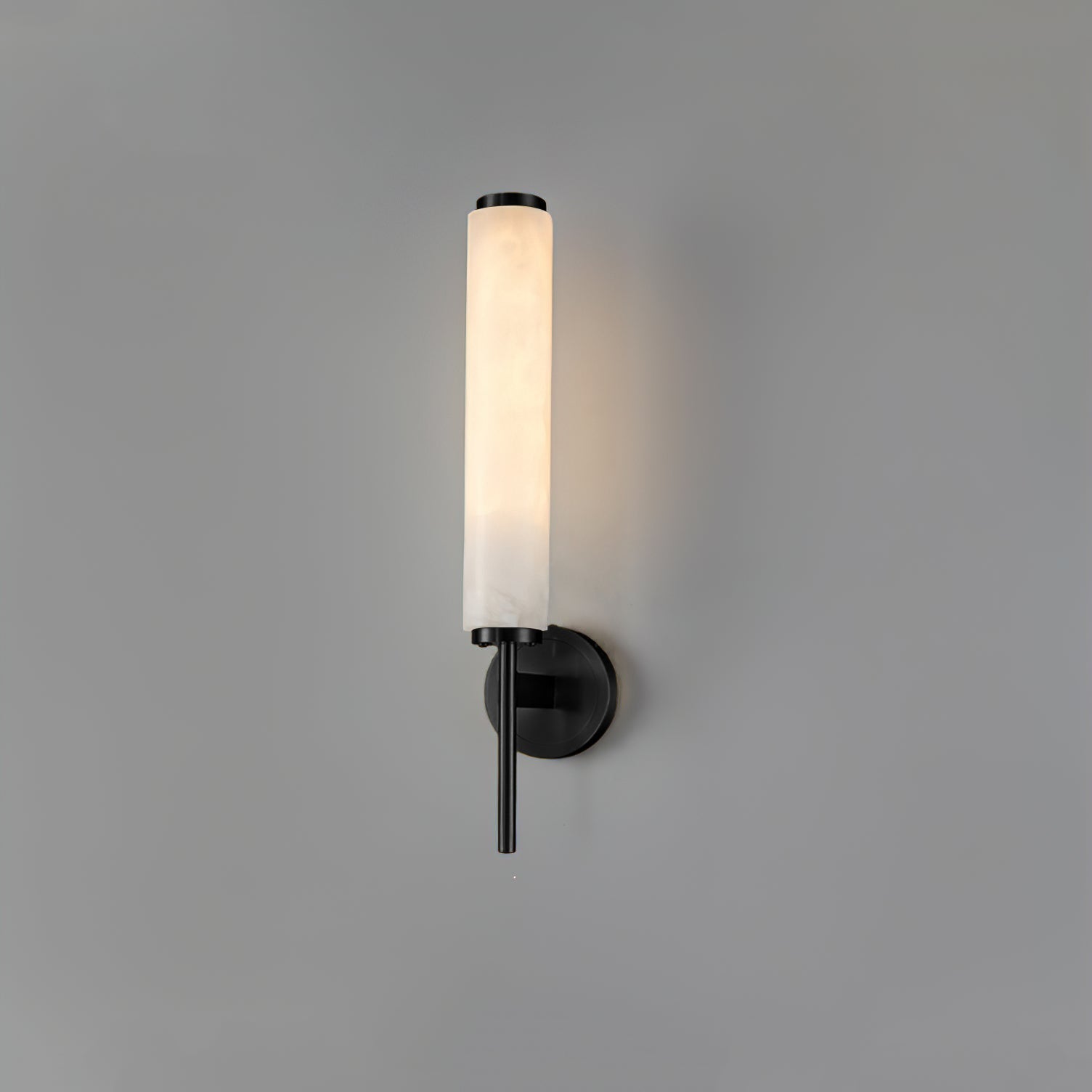 The Clérachic Olrinyra in black, its alabaster tube standing above a matte disc plate and downward stem.