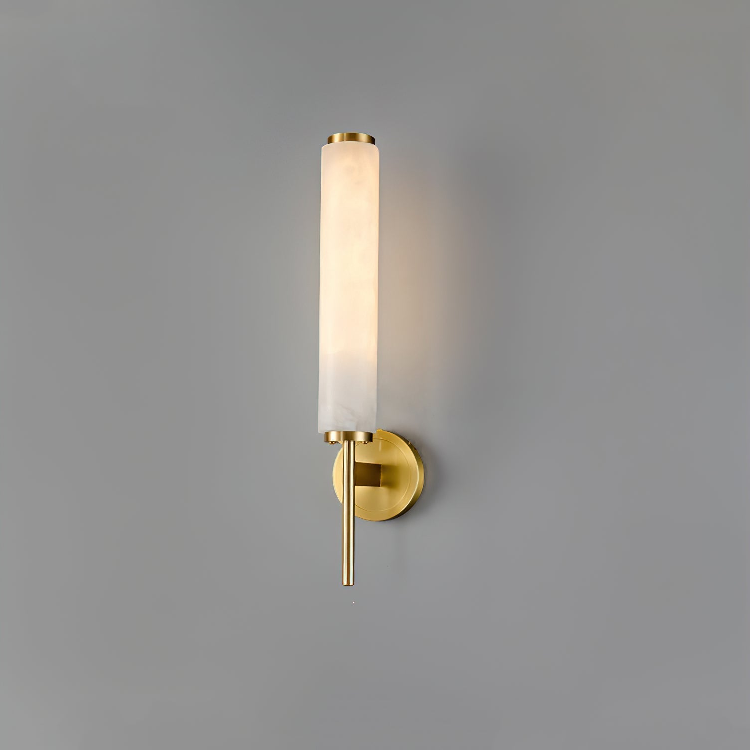 Clérachic Olrinyra in brass seen from a slight angle, the stone cylinder's veining visible along its length.