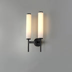 Clérachic Olrinyra twin version in black, both alabaster cylinders lit and staggered across the wall.