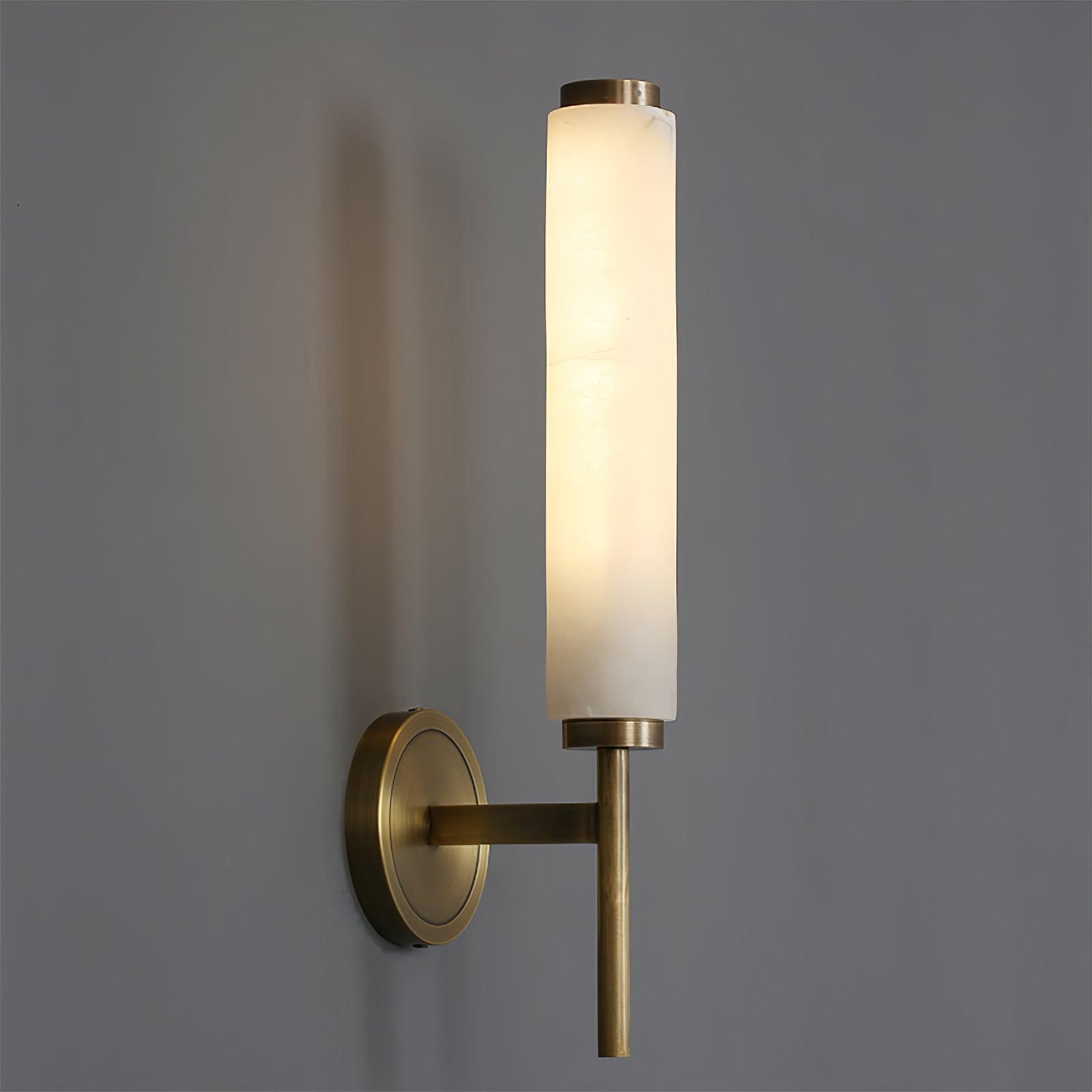 The Clérachic Olrinyra in brass seen from the side, the alabaster cylinder seated on its slim level arm.