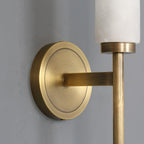 Close view of the Clérachic Olrinyra's brass disc backplate and arm meeting the base of the alabaster tube.
