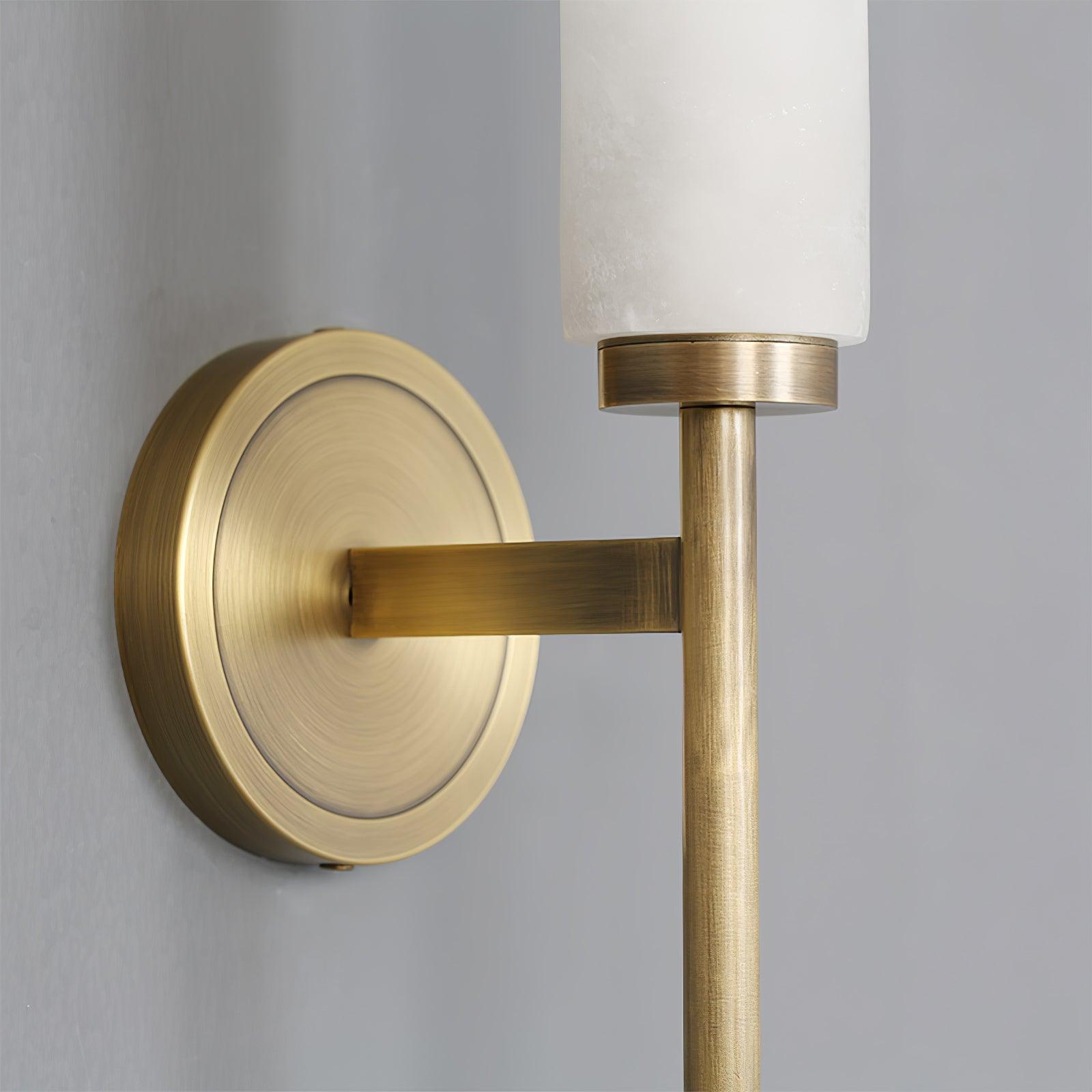 The Clérachic Olrinyra's turned brass backplate seen up close, its arm cradling the foot of the stone tube.