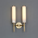The Clérachic Olrinyra twin in brass, both cylinders lit and set either side of a single round backplate.