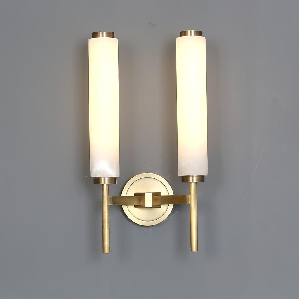 Clérachic Olrinyra twin in brass with the tubes spaced wide, both lit above the shared brass wall mount.