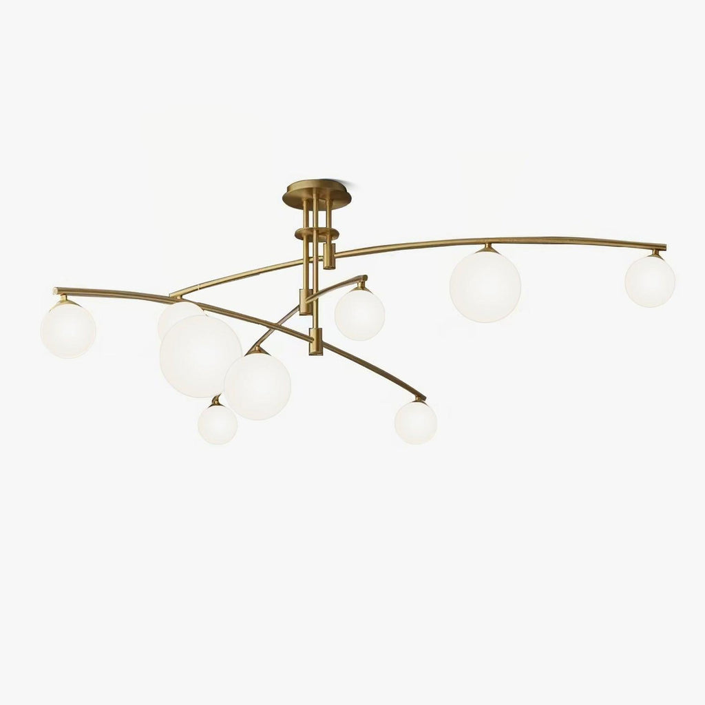 Gold Clérachic chandelier with long curved arms and frosted opal globes of different sizes, on a plain white backdrop.
