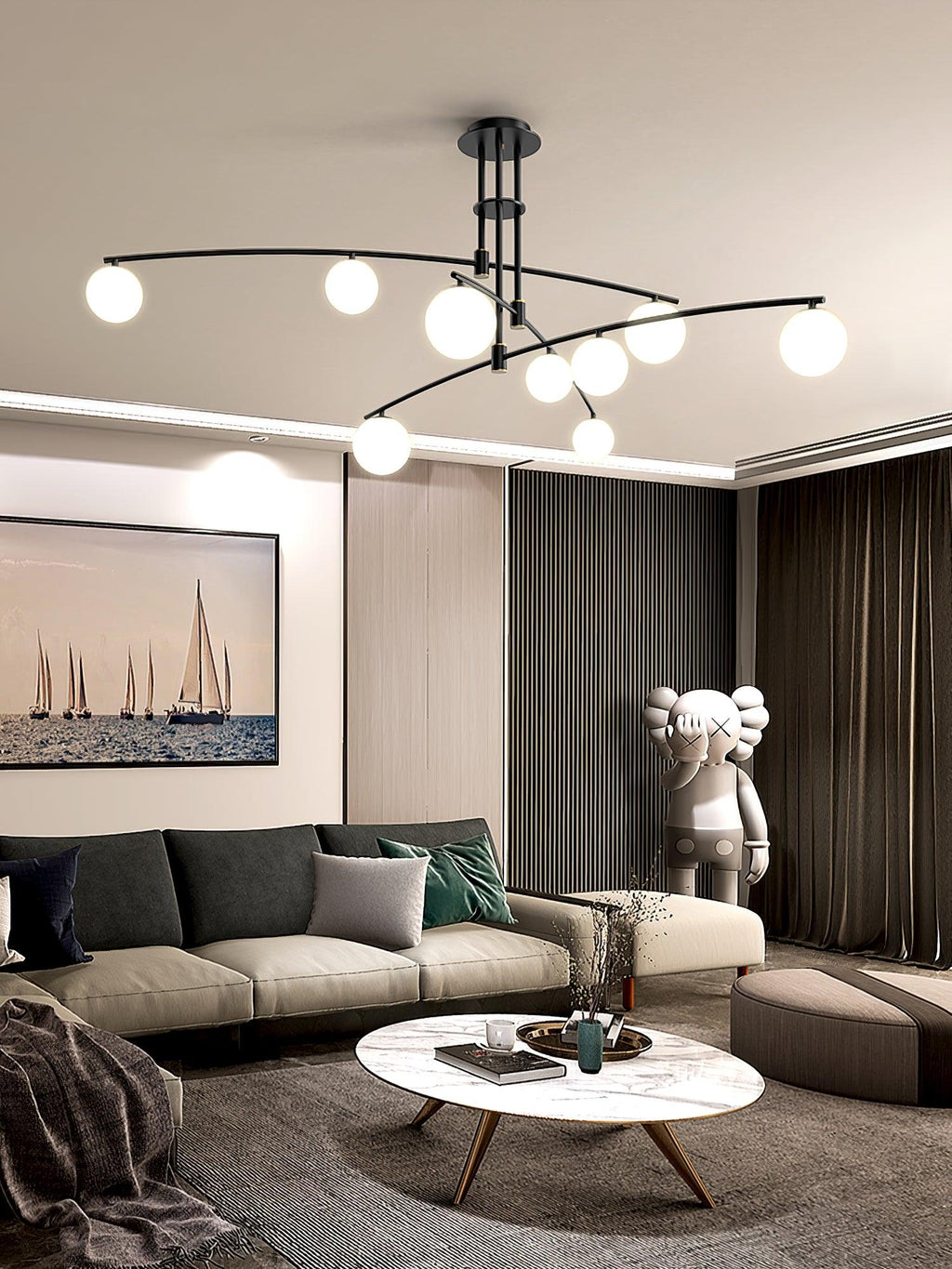 Black Clérachic globe chandelier above a living room with a sail-boat print, a marble coffee table and dark drapes.