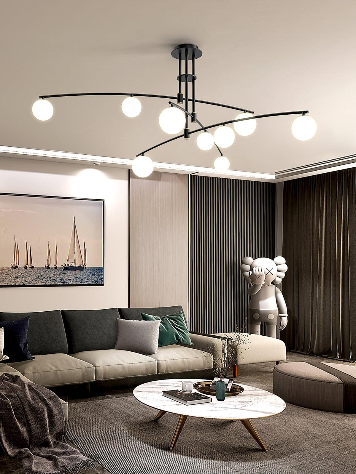 Black Clérachic globe chandelier above a living room with a sail-boat print, a marble coffee table and dark drapes.