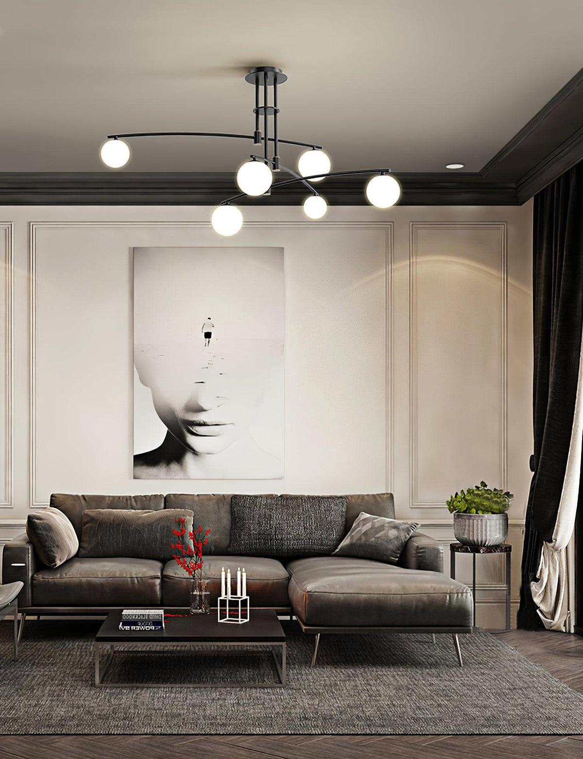 Black Clérachic chandelier in a room with a dark cornice, a large monochrome portrait and a grey corner sofa below.
