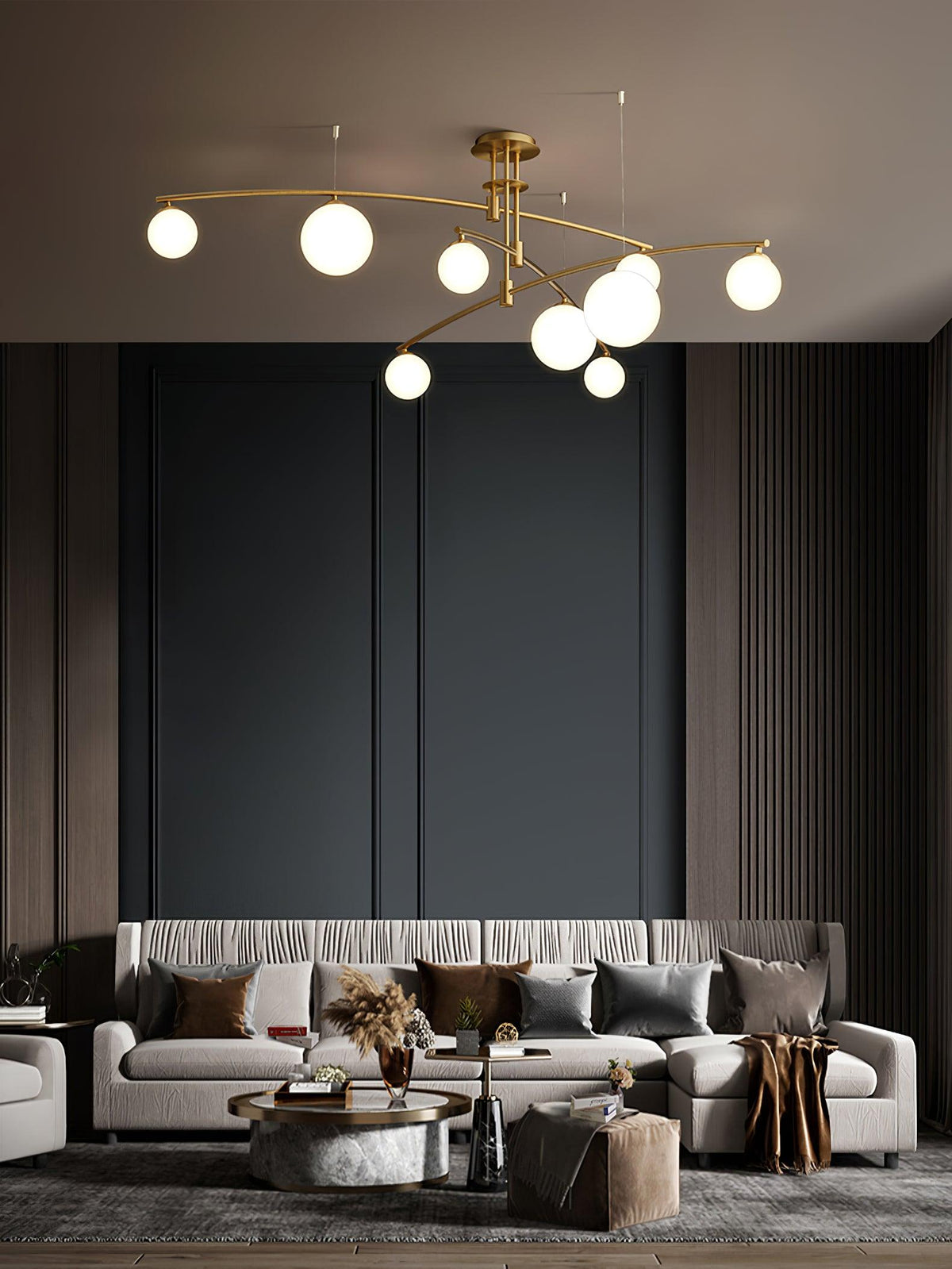 Gold Clérachic chandelier with opal globes above a cream sofa with brown cushions, against dark wood-panelled walls.