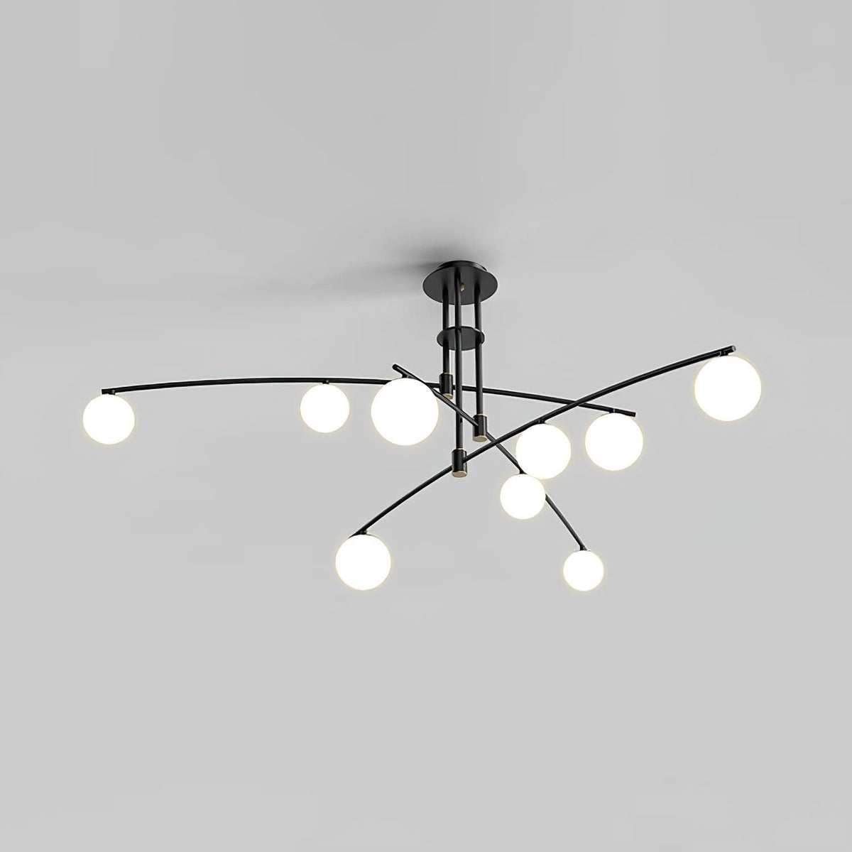 Black Clérachic chandelier with nine opal globes on curved arms, lit, shown on a plain grey backdrop.