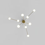 View from below of the Clérachic gold chandelier, its arms spreading from the centre like a star with a lit globe at each end.