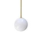 Glossy opal glass sphere on a brass rod, this Clérachic pendant shown on a plain white backdrop.