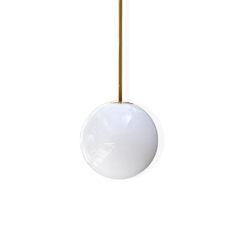 Glossy opal glass sphere on a brass rod, this Clérachic pendant shown on a plain white backdrop.