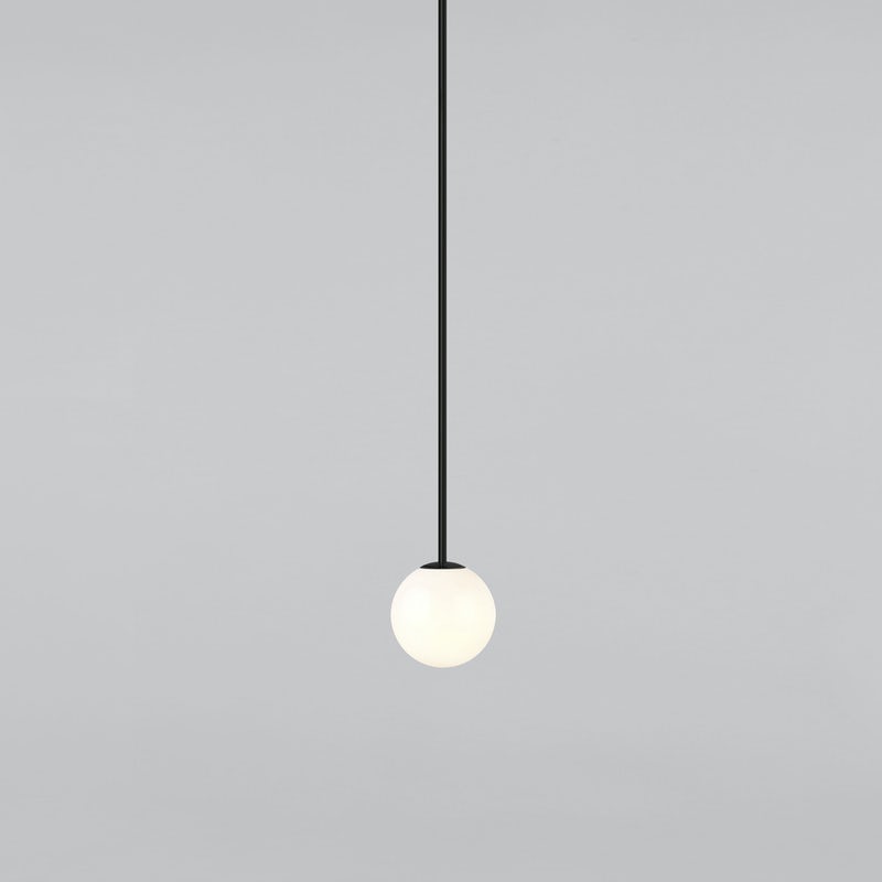 Small opal sphere on a long black rod with a black cap, this Clérachic pendant on a light grey backdrop.