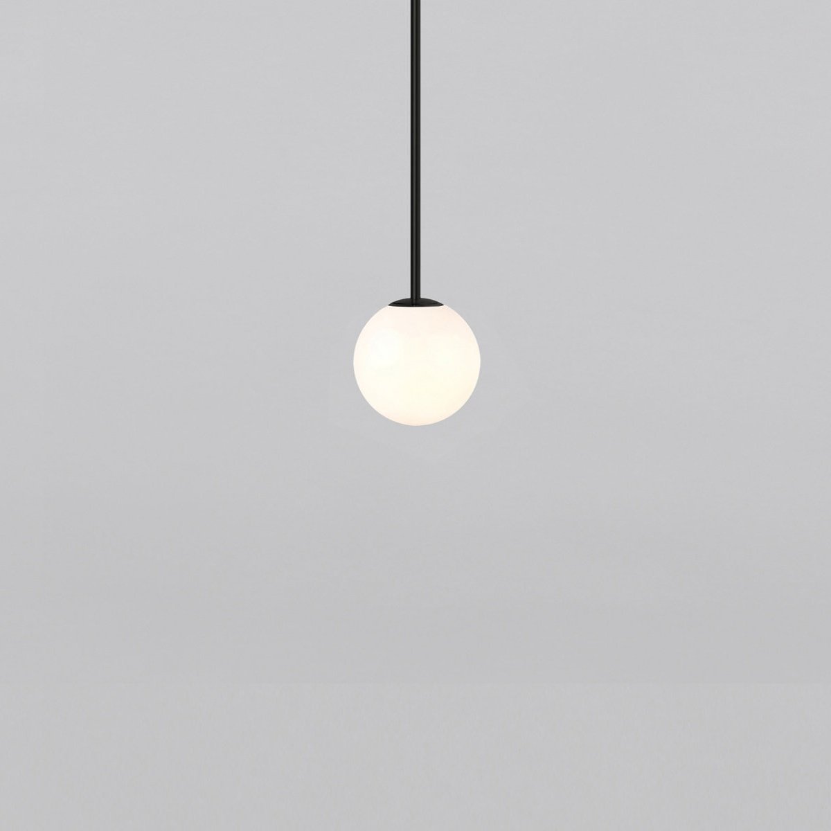 Opal sphere on a short black rod, this Clérachic pendant on a light grey backdrop.