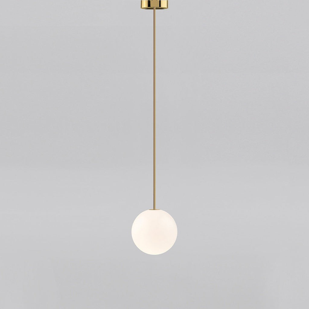 Small opal sphere on a brass rod with a brass ceiling cap, this Clérachic pendant on a light grey backdrop.