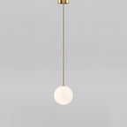 Small opal sphere on a brass rod with a brass ceiling cap, this Clérachic pendant on a light grey backdrop.