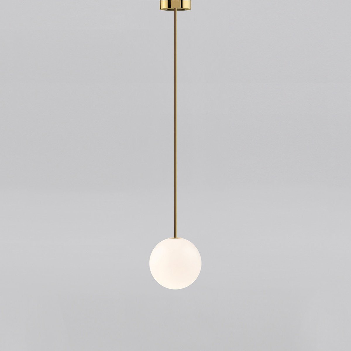 Small opal sphere on a brass rod with a brass ceiling cap, this Clérachic pendant on a light grey backdrop.