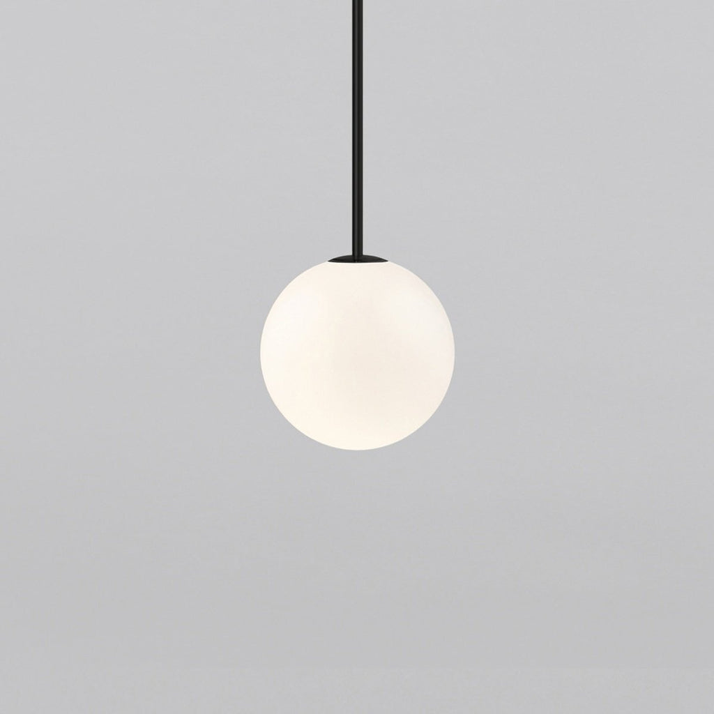 Opal sphere hanging from a short black rod, this Clérachic pendant filling more of the frame on a light grey backdrop.