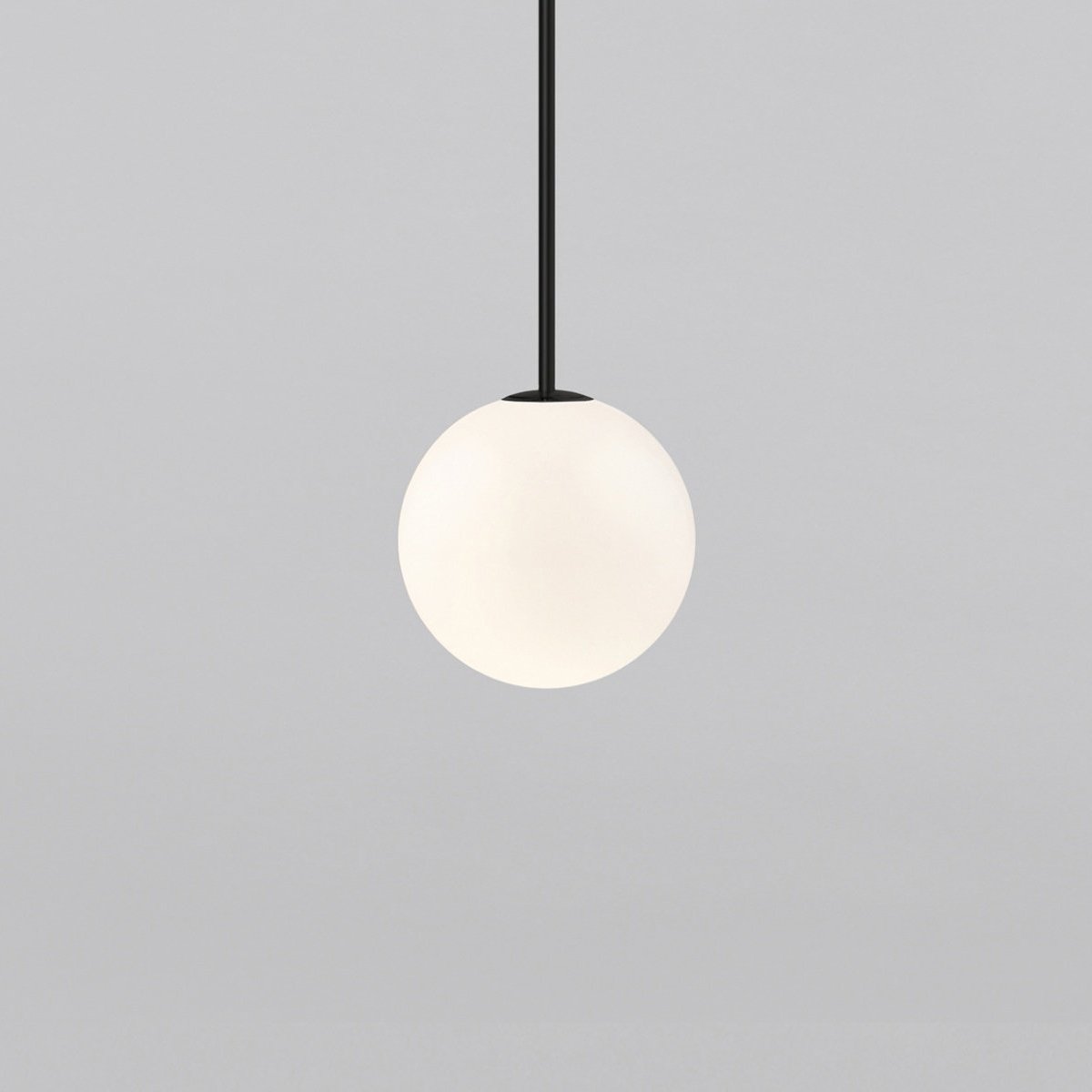 Opal sphere hanging from a short black rod, this Clérachic pendant filling more of the frame on a light grey backdrop.