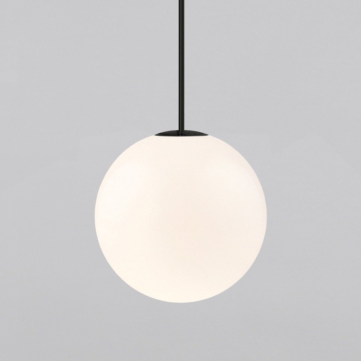Very large opal sphere on a black rod, this Clérachic pendant filling most of the frame on a light grey backdrop.
