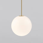 Large opal sphere on a brass rod, this Clérachic pendant filling most of the frame on a light grey backdrop.