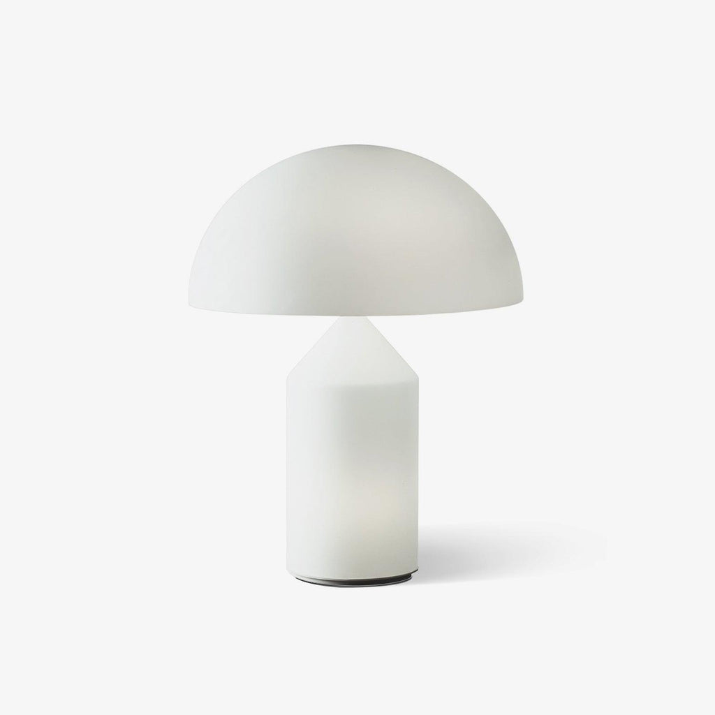 This Clérachic table lamp on a plain white backdrop, a milk-white glass dome shade over a smooth cone-topped cylinder base.