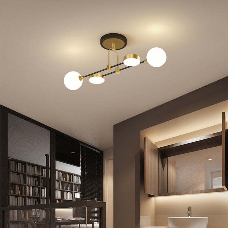 The Clérachic Opal Globe Ceiling Light in its slim 4-light bar layout, mounted over a bathroom vanity beside an open bookshelf.