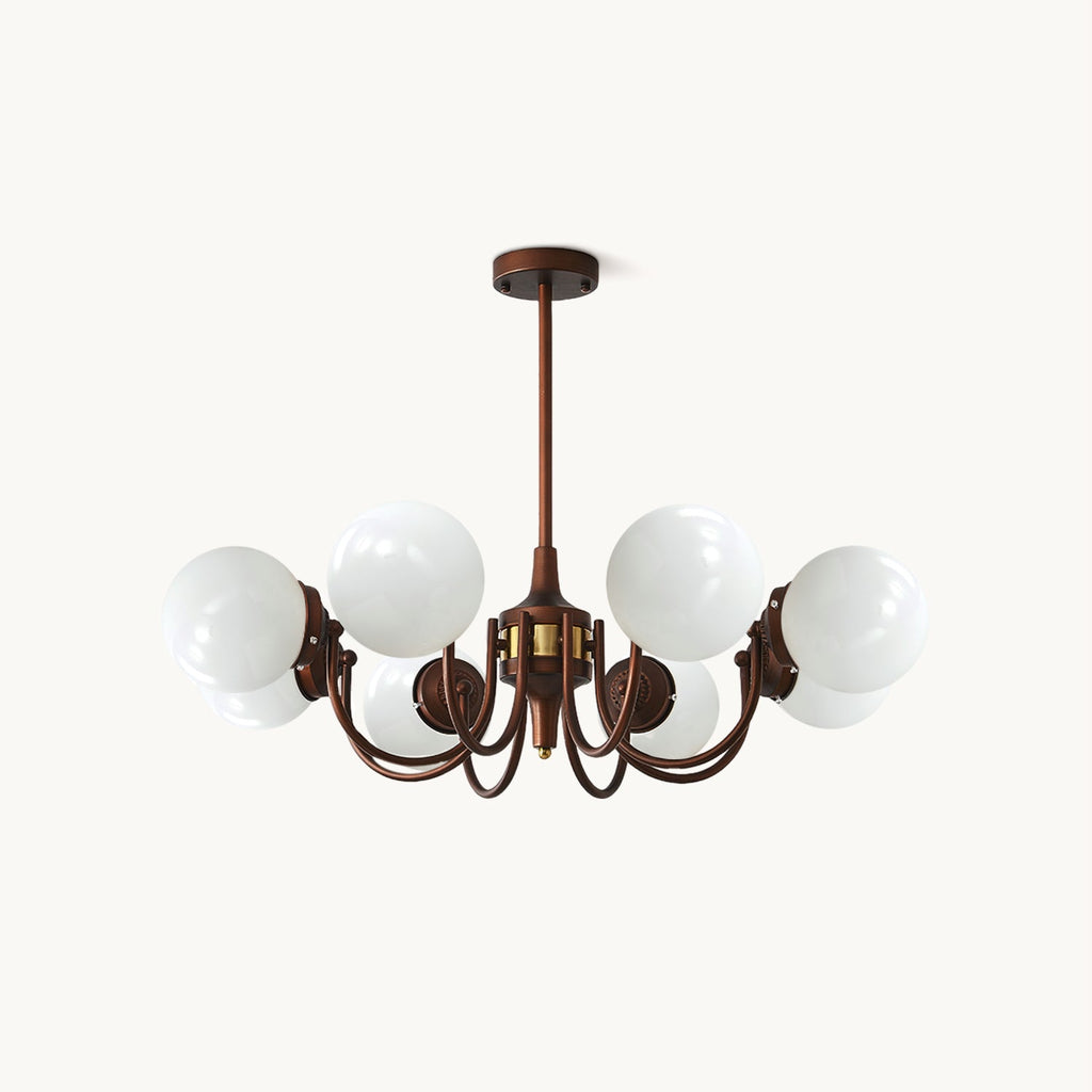 Eight-light Clérachic chandelier with white glass globes on curved antique bronze arms and a short rod, on a plain white backdrop.