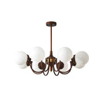 Cut-out view of this Clérachic chandelier with eight white glass globes and antique bronze arms on a plain white backdrop.
