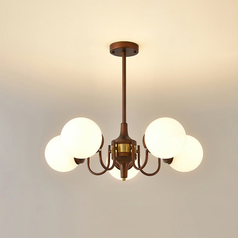Five-globe Clérachic chandelier on a short rod, lit against a pale ceiling with a warm glow.
