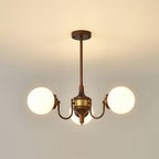 Three-light Clérachic chandelier lit with white globes on curved bronze arms and a brass band, hung from a short rod.