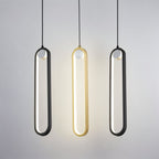 Clérachic black and gold stadium-shaped LED pendant lights side by side, the gold one lit, against a pale grey wall.