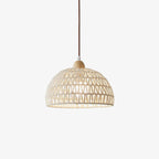 Open-weave Clérachic pendant light on a plain white backdrop, a natural dome shade with a small wooden finial on a brown cord.