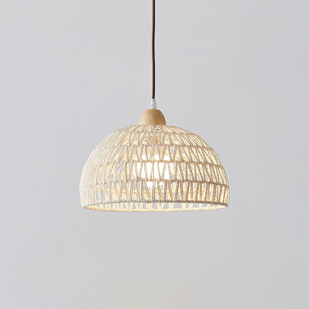 Close, straight-on view of this Clérachic pendant on a pale grey backdrop, showing the zigzag open weave of the dome and its wooden finial.
