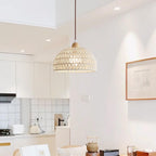 Clérachic dome pendant hanging in a bright open-plan kitchen, a framed picture to the right and a tea set on the counter below.
