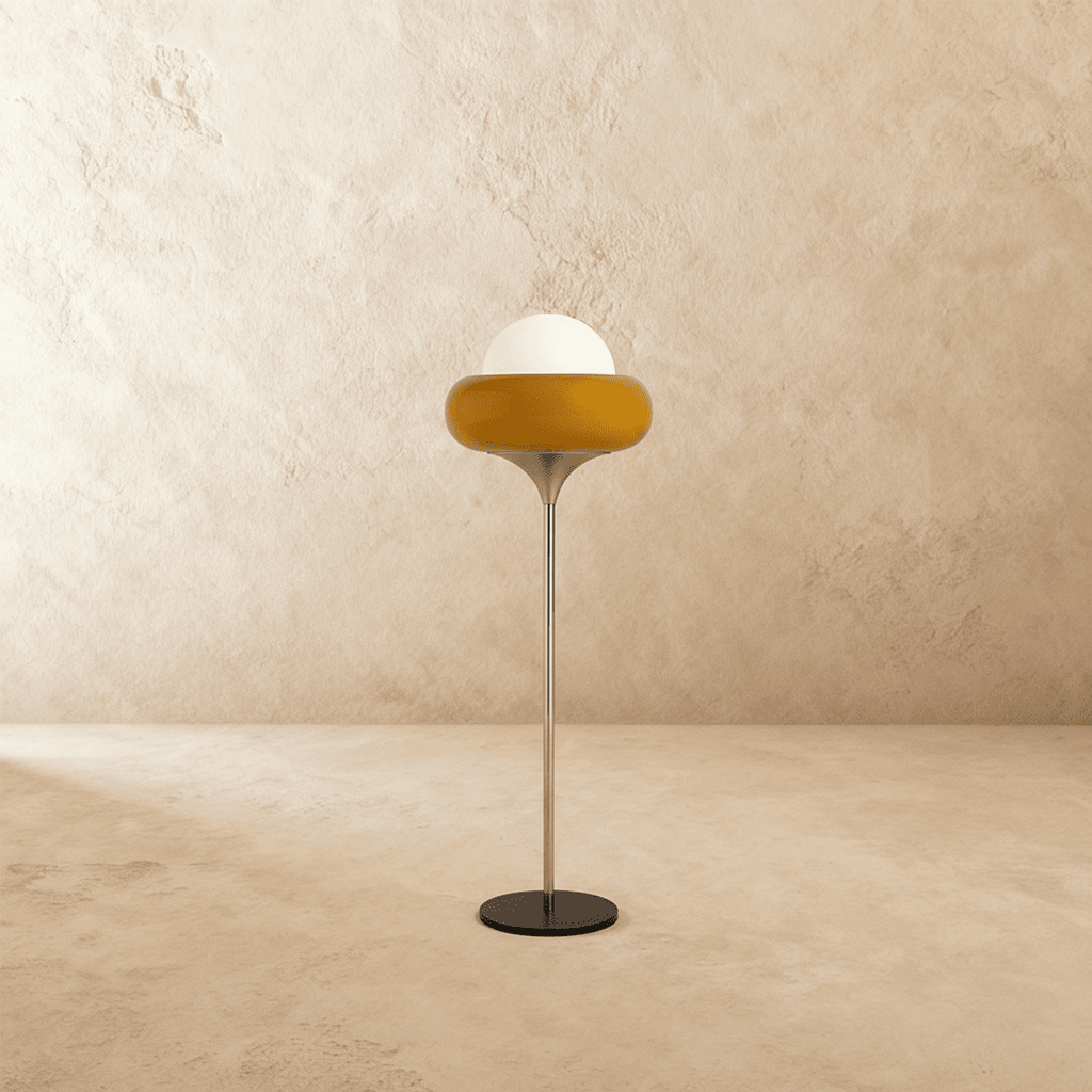 Clérachic floor lamp in yellow glass, shown side-on with its slim chrome stem and round black metal base.