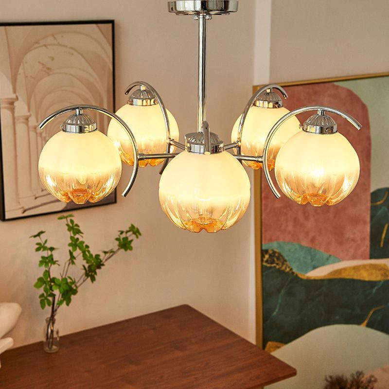 Clérachic chandelier lit, the glow through the shade in a quiet room.
