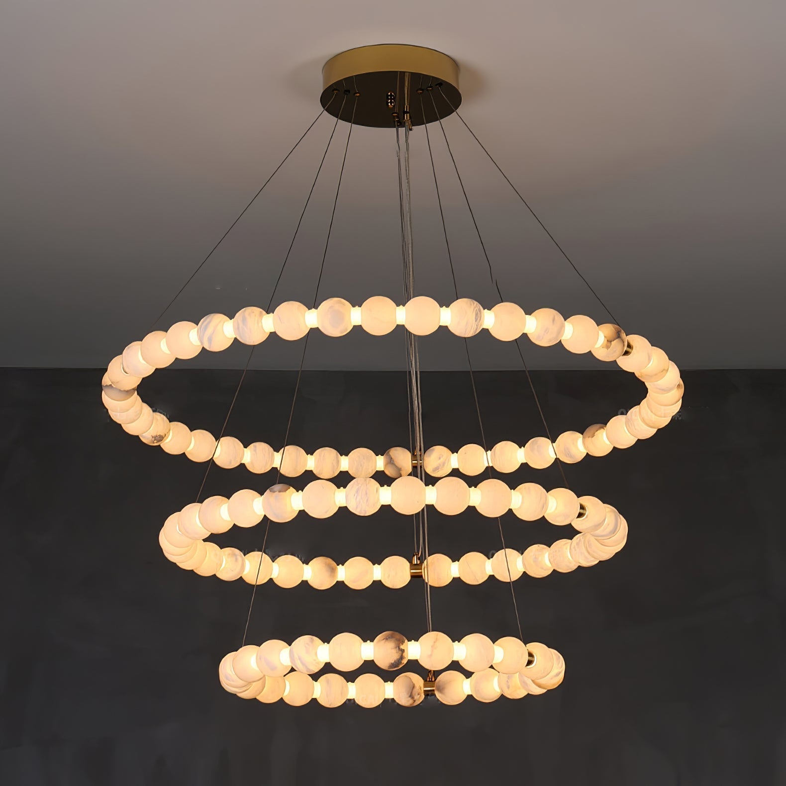 Clérachic Orb chandelier in a three-ring build, the tiers narrowing towards the floor.
