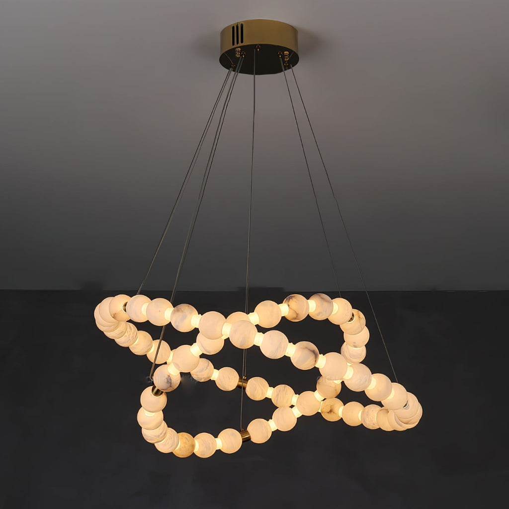 Clérachic Orb chandelier lit in a low spiral, beads doubling back beneath the top ring.
