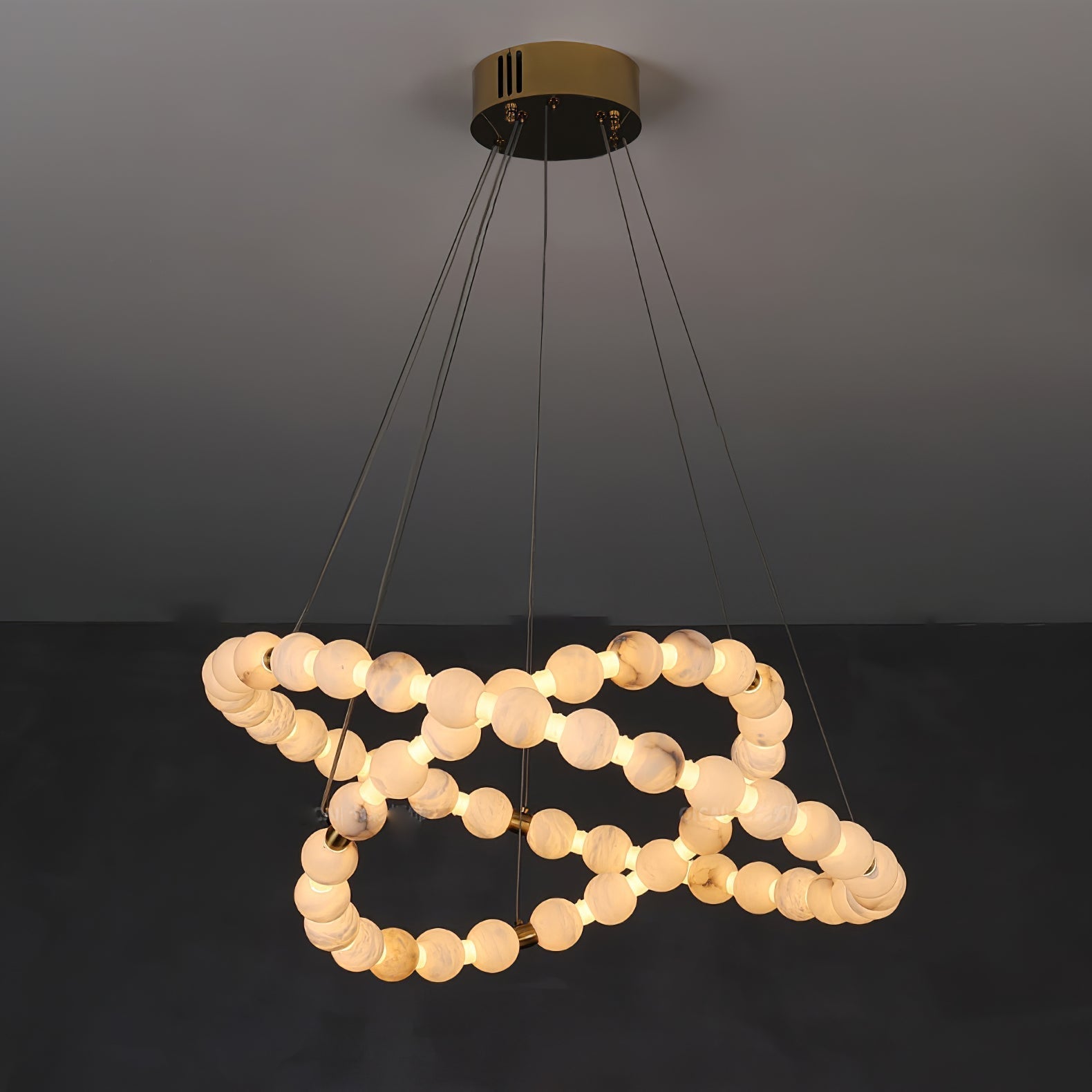 Clérachic Orb chandelier lit in a low spiral, beads doubling back beneath the top ring.