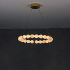 Clérachic Orb ring chandelier lit on grey, a level circle of stone beads on slim cables.