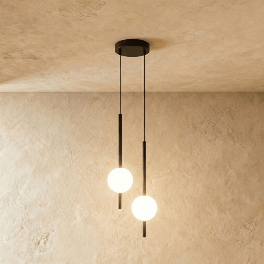 Clérachic twin-head orb pendant light in matte black, two rods and globes dropping from one round ceiling canopy.
