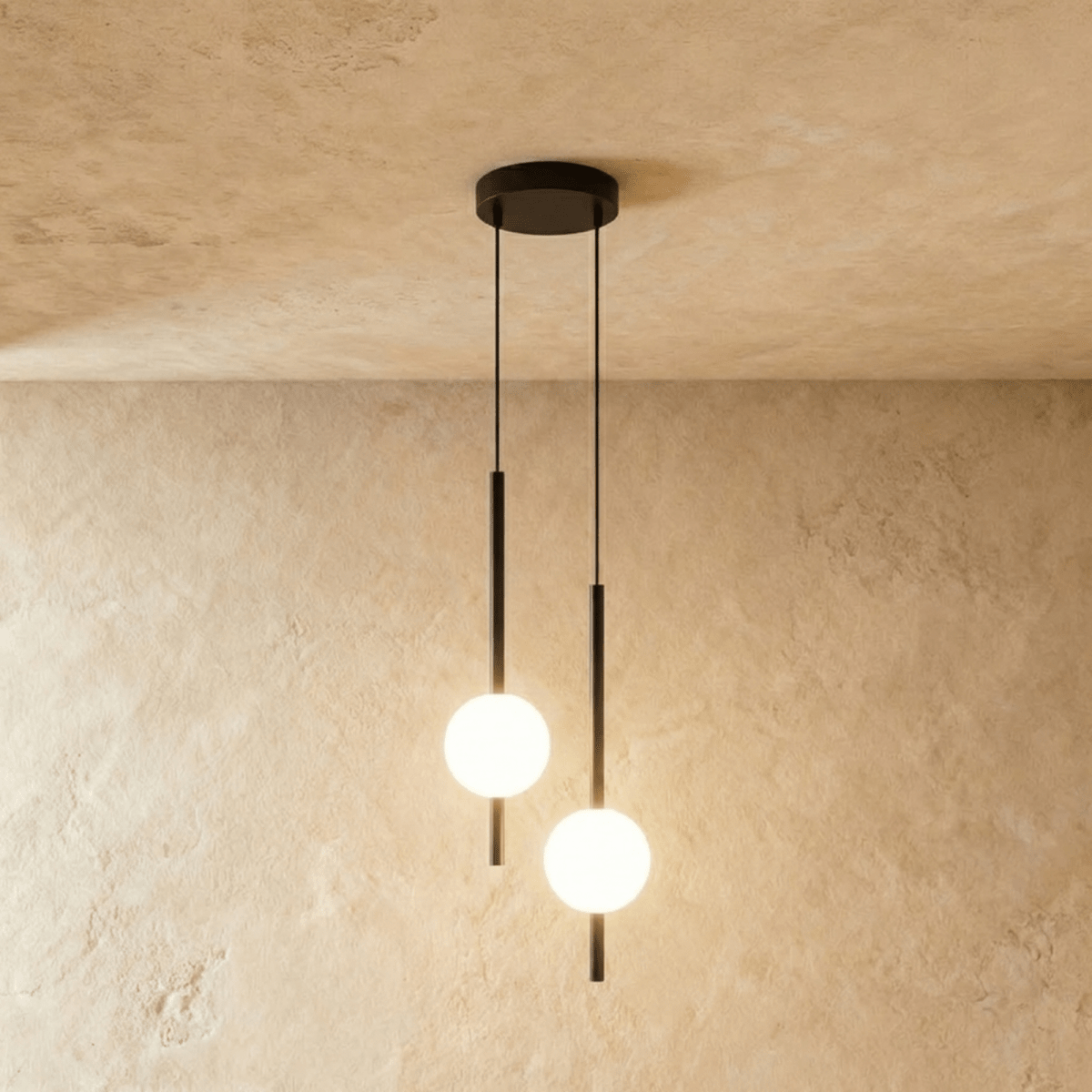 Clérachic twin-head orb pendant light in matte black, two rods and globes dropping from one round ceiling canopy.